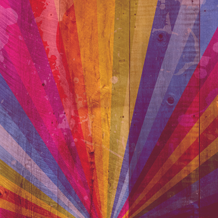 A rainbow is painted on wood slats. Click to access the LGBTQ+ resource guide.