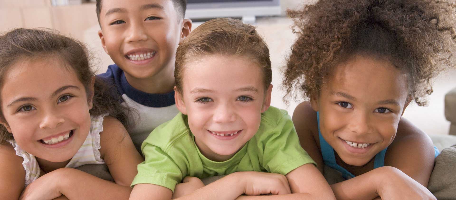 A diverse group of children smile for the camera