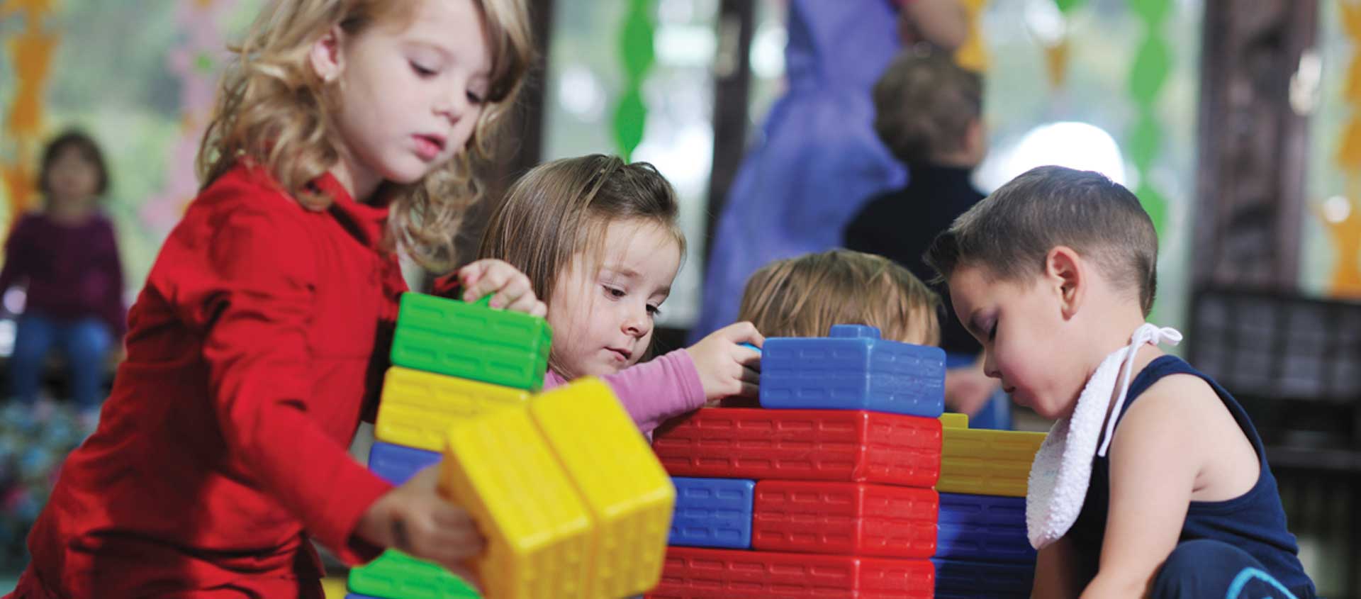 Preschool-aged children build with blocks in a day care setting
