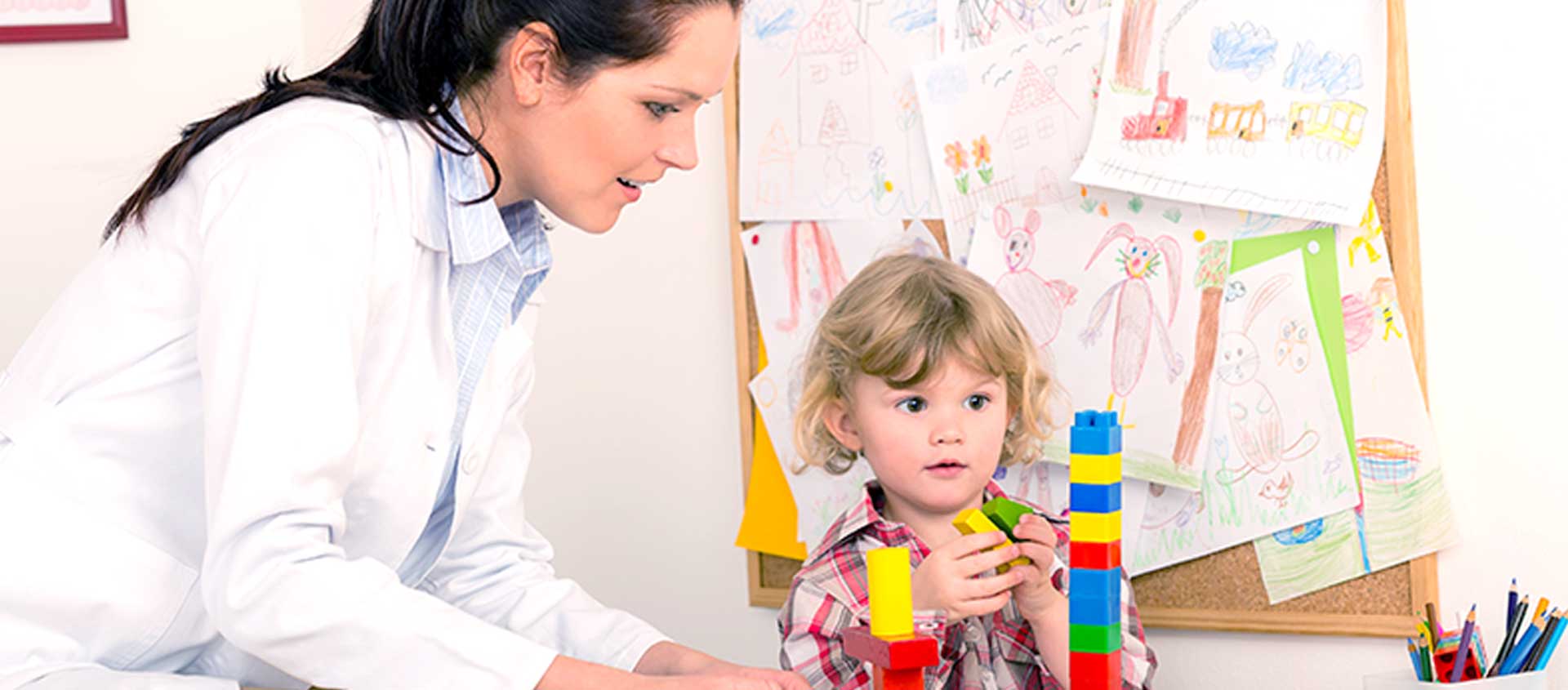 A provider observes a child stacking blocks